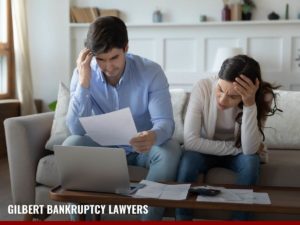 Worried couple understanding the benefits and downfalls of debt consolidations with tips from Gilbert Bankruptcy Lawyers blog