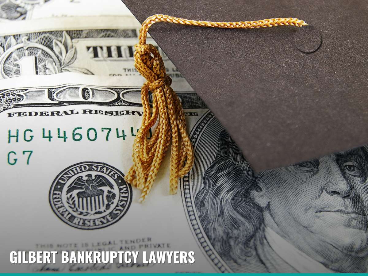 A graduation cap rests on U.S. currency, symbolizing the financial burden of student loan debt